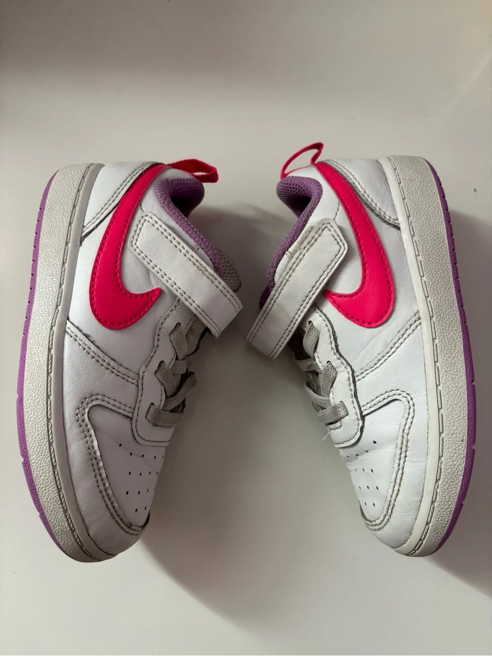 Nike White Sneakers with Bright Pink Swoosh and Lavender Soles